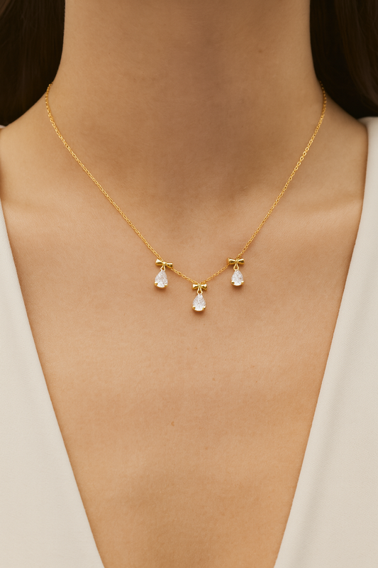 18k gold plated white crystal bow necklace by Juwelenn – gold necklace with teardrop white stones and bow charms