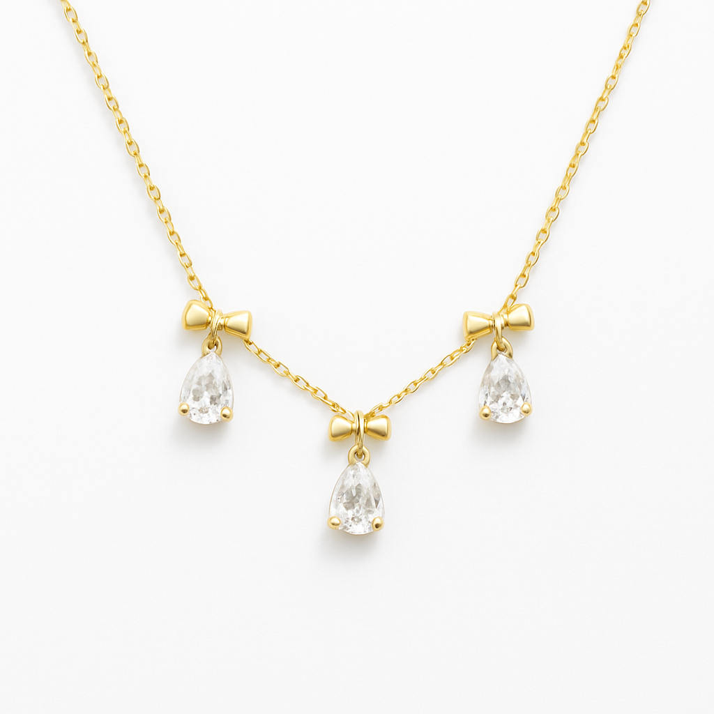 18k gold plated white crystal bow necklace by Juwelenn – gold necklace with teardrop white stones and bow charms
