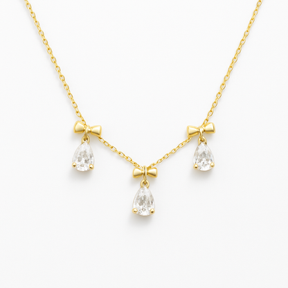 18k gold plated white crystal bow necklace by Juwelenn – gold necklace with teardrop white stones and bow charms
